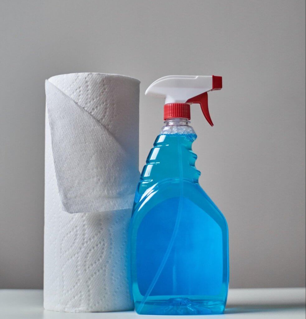 A roll of paper towel and glass cleaner