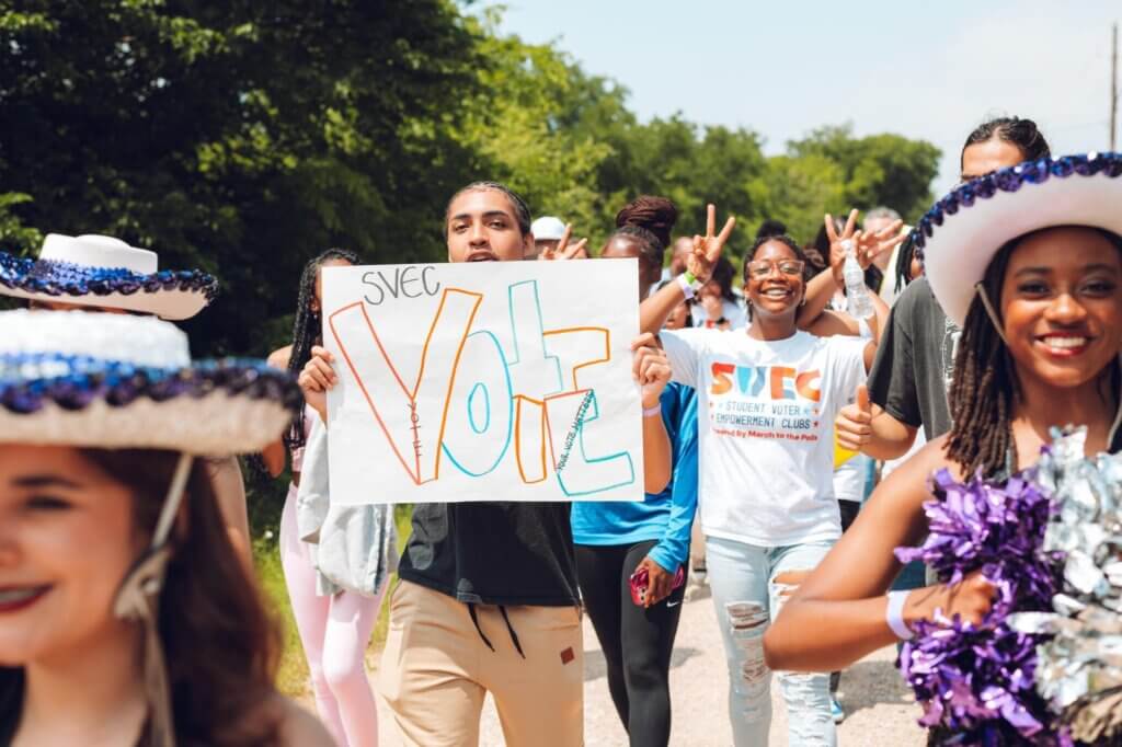 March to the Poll group with Vote sign